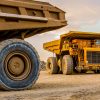 Machinery and dumping trucks outside a coal mining site