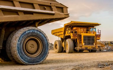 Machinery and dumping trucks outside a coal mining site
