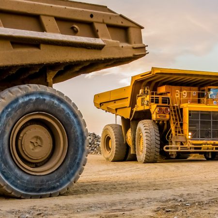 Machinery and dumping trucks outside a coal mining site